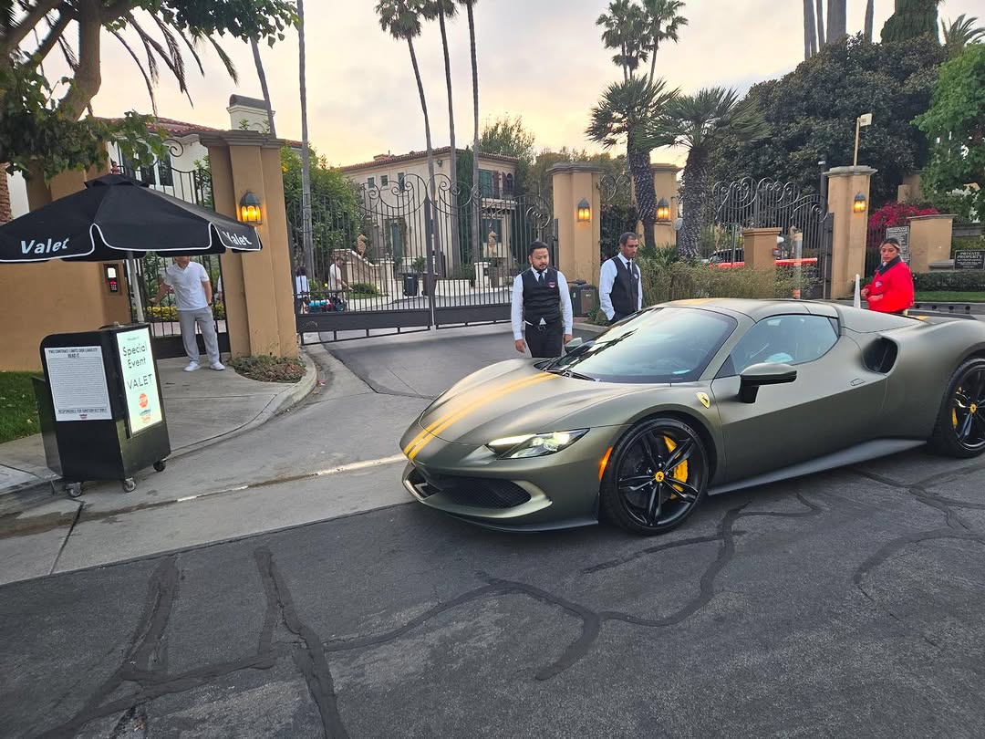 American Valet Parking Response attendants at a special-event valet stand beside a luxury sports car at a gated Southern California estate