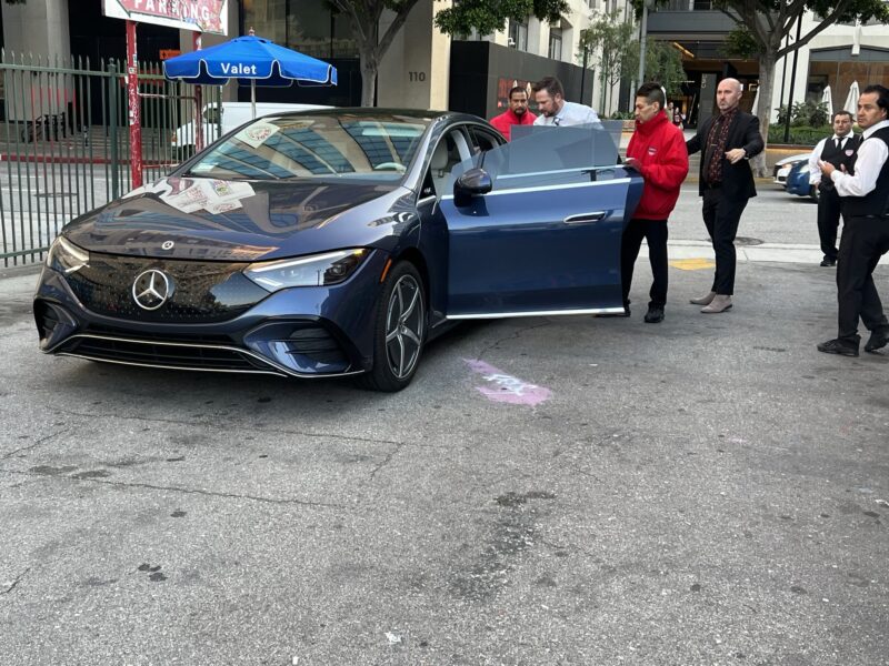 AVPR valet attendants assisting a Mercedes at an urban curb