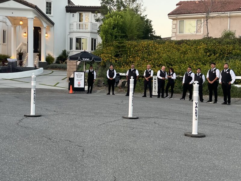 AVPR special-event valet crew positioned beside valet posts and a service stand