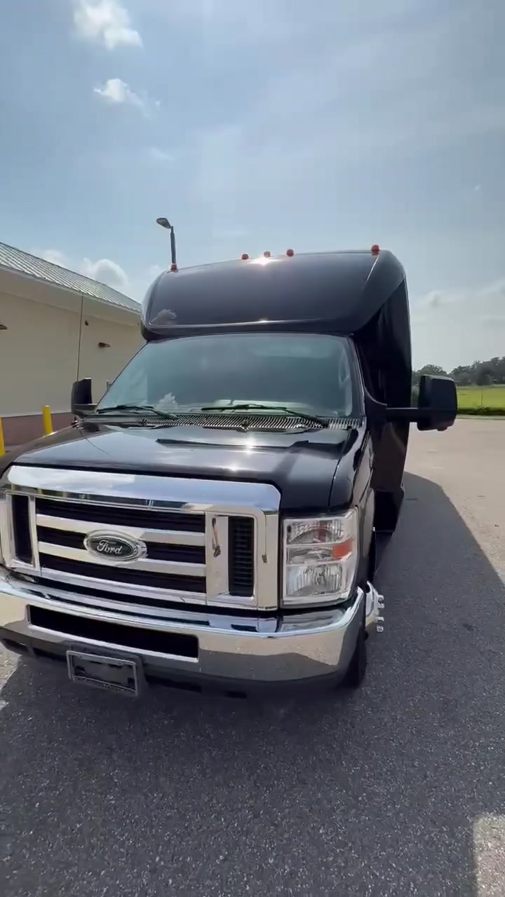 Front view of AVPR's black 24-passenger shuttle bus