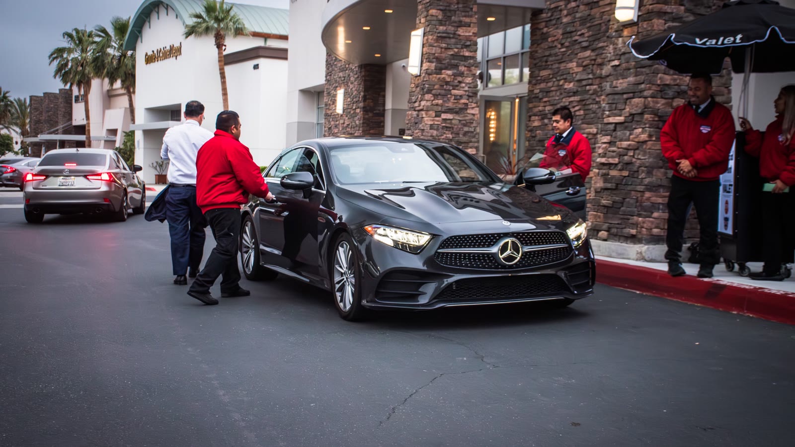 American Valet Parking valet attendants coordinating vehicle arrivals at an event venue.